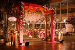 a decorated arch with flowers and lights